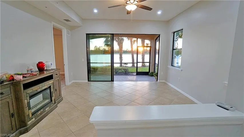 Living room featuring ceiling fan and light tile patterned floors