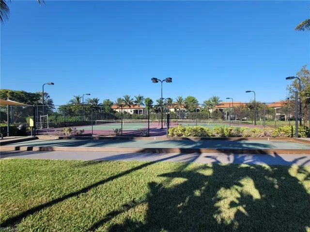 Surrounding community featuring a lawn and tennis court