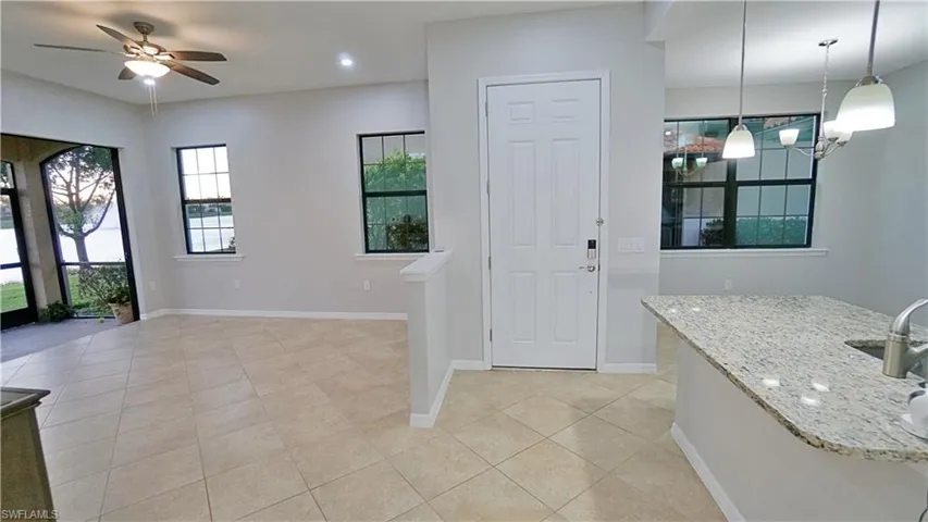 Foyer with ceiling fan and light tile patterned floors