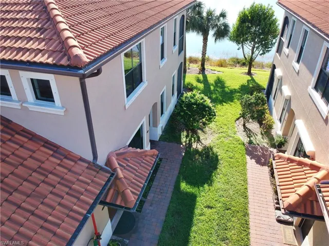 View of side of home featuring a lawn
