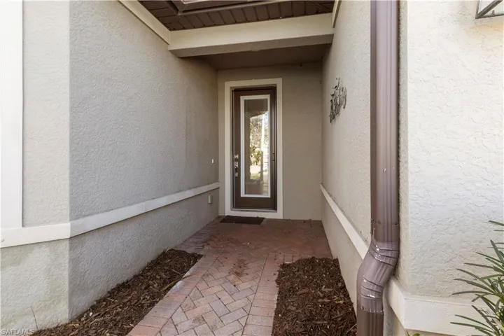Entrance to property with stucco siding