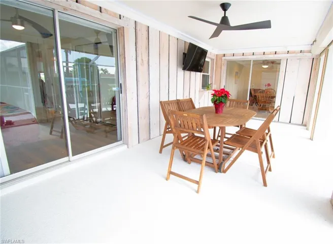 Carpeted dining space featuring ceiling fan