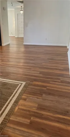 Unfurnished room featuring wood finished floors and baseboards