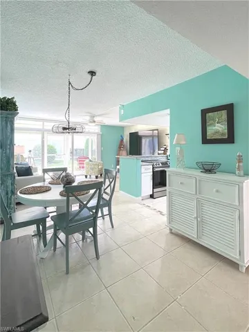 Dining area featuring a textured ceiling and light tile patterned floors