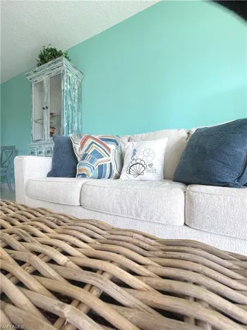 Living area featuring vaulted ceiling and a textured ceiling