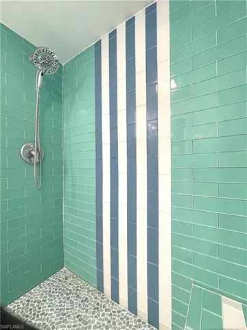 Full bath featuring tiled shower