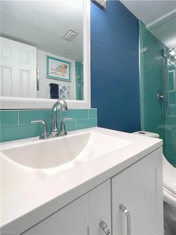 Full bathroom featuring vanity and a tile shower
