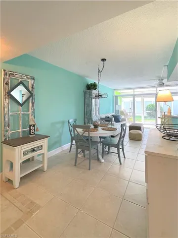 Dining room with a textured ceiling and light tile patterned floors