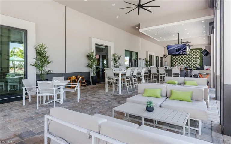 View of patio / terrace with an outdoor living / dining area and a ceiling fan