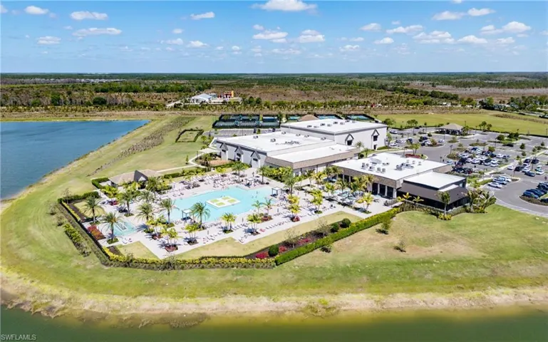 Bird's eye view of a nearby body of water and a pool