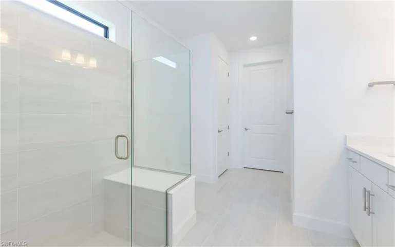 Full bathroom featuring vanity, a stall shower, and recessed lighting
