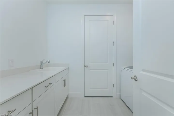 Bathroom with vanity and washer / dryer