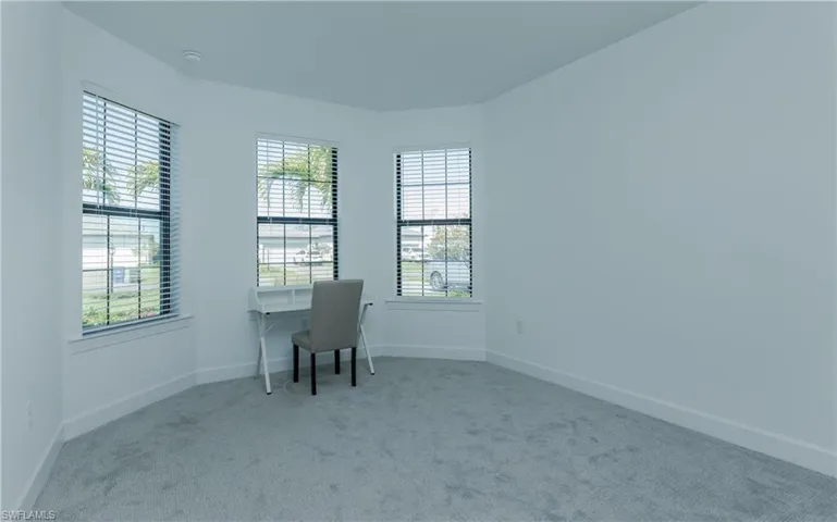 Unfurnished office with light colored carpet and healthy amount of natural light