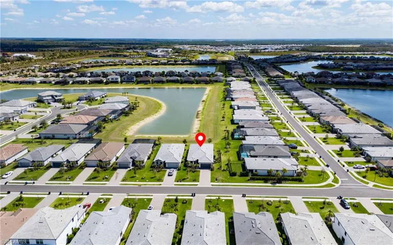 Aerial view of property's location featuring nearby suburban area and a nearby body of water