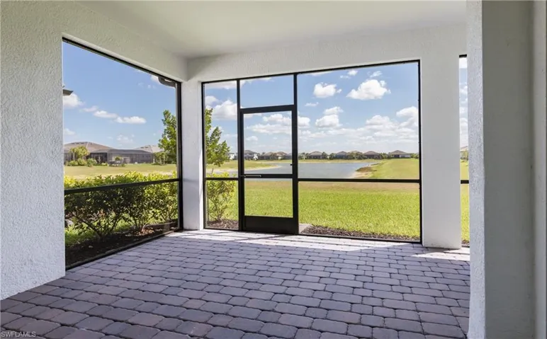 Unfurnished sunroom with a residential view and a water view