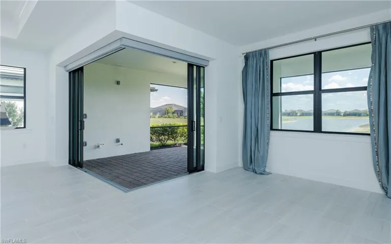 Empty room with plenty of natural light and a residential view