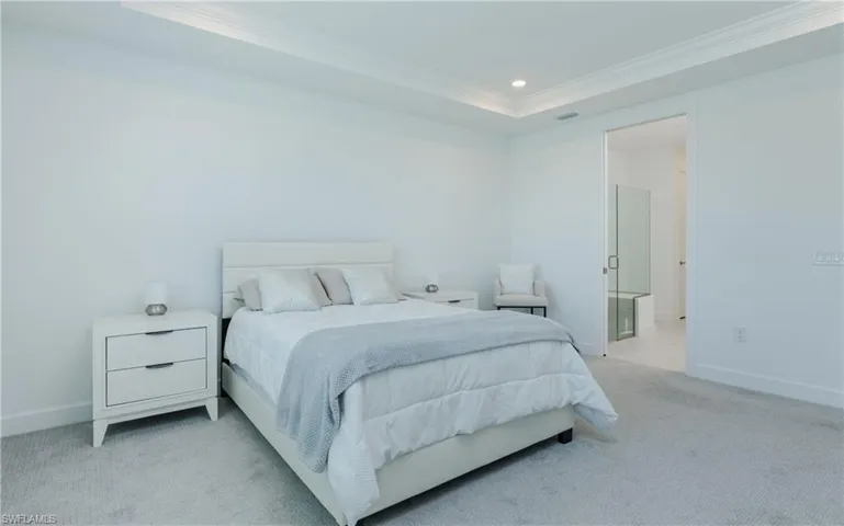 Bedroom with light carpet, ornamental molding, recessed lighting, and connected bathroom