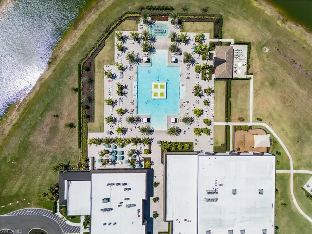 Bird's eye view of a pool and a nearby body of water