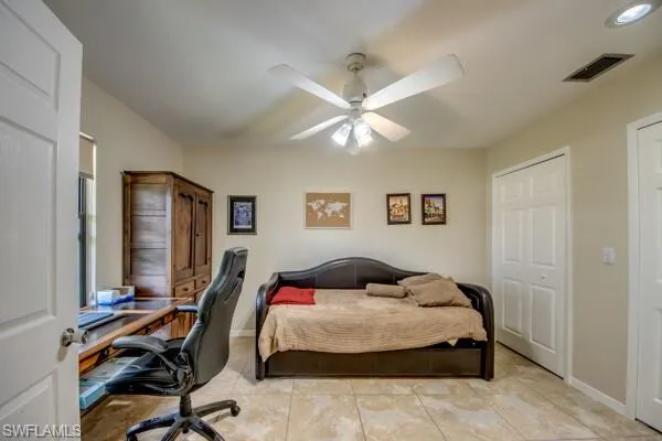 Bedroom featuring light tile patterned floors and ceiling fan
