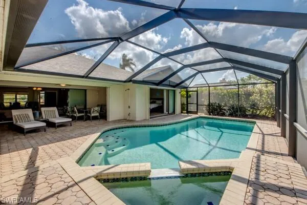 View of pool featuring a patio and a lanai