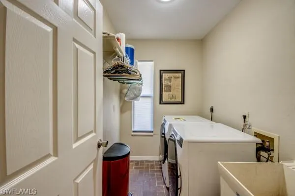 Laundry room featuring washer and dryer and sink