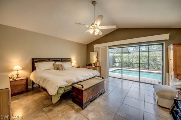 Tiled bedroom with access to outside, vaulted ceiling, and ceiling fan