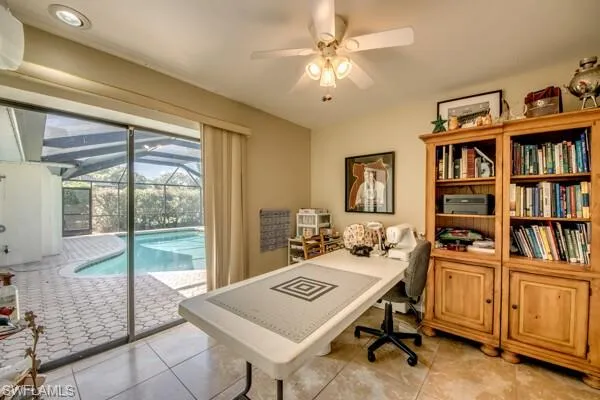 Office area with light tile patterned flooring and ceiling fan