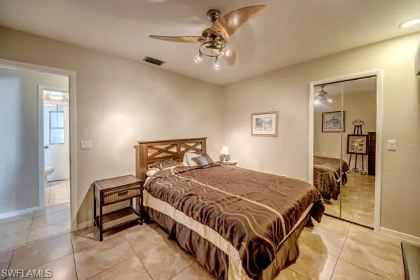 Bedroom featuring a closet, ceiling fan, and light tile patterned floors