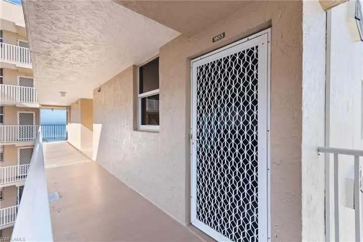 Doorway to property featuring stucco siding