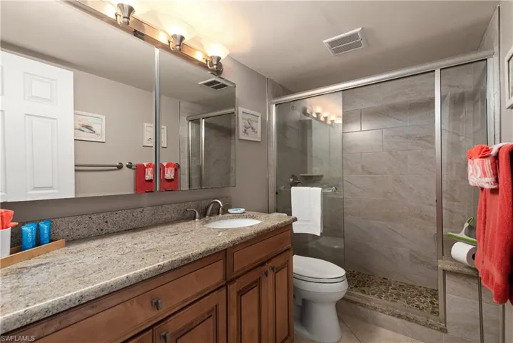 Full bath with vanity and a shower stall