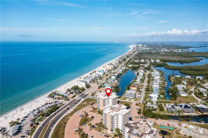 View of property location on Bonita Beach Rd across from Doc's Beach House restaurant with extended coastline.