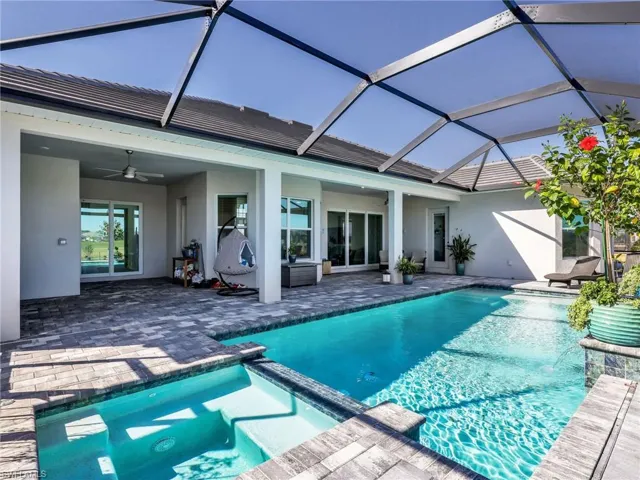 Integrated pool / spa featuring a patio, a sunroom, and a lanai