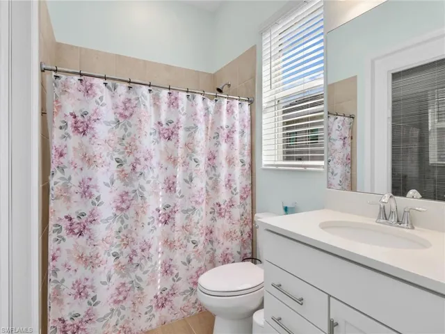 Bathroom featuring vanity and curtained shower