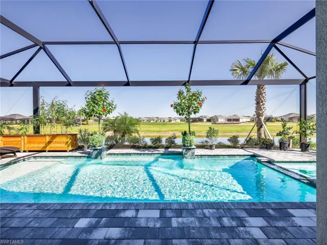 Integrated pool / hot tub featuring a residential view, a lanai, and a sunroom