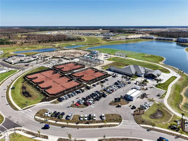 Aerial view of property's location with a nearby body of water and a golf club