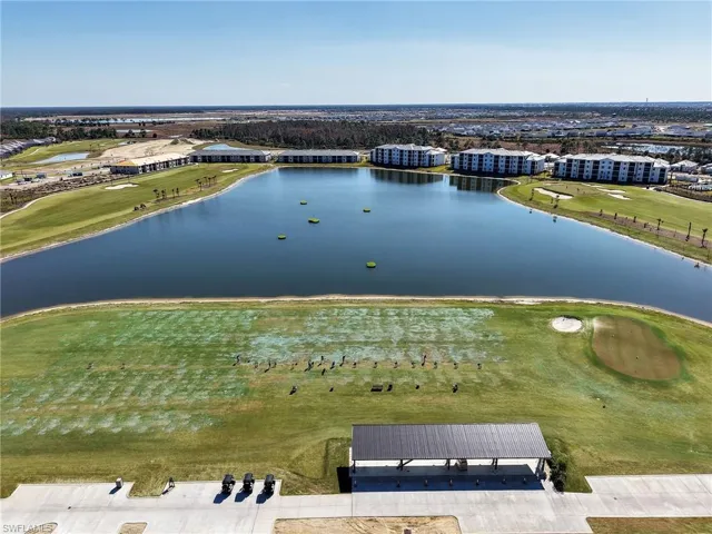 Drone / aerial view of a golf club and a nearby body of water