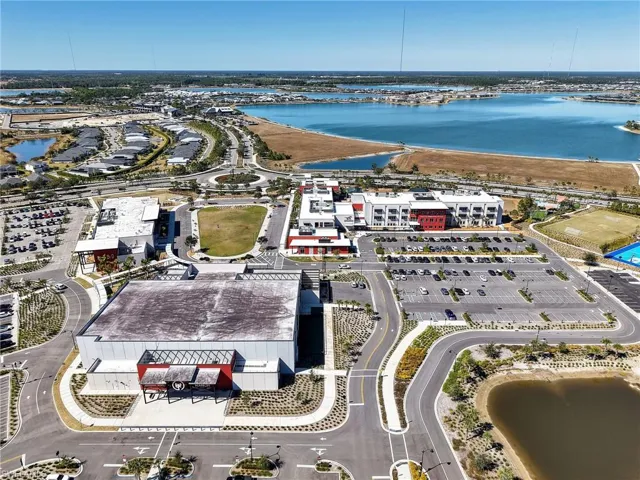 Aerial overview of property's location with a nearby body of water
