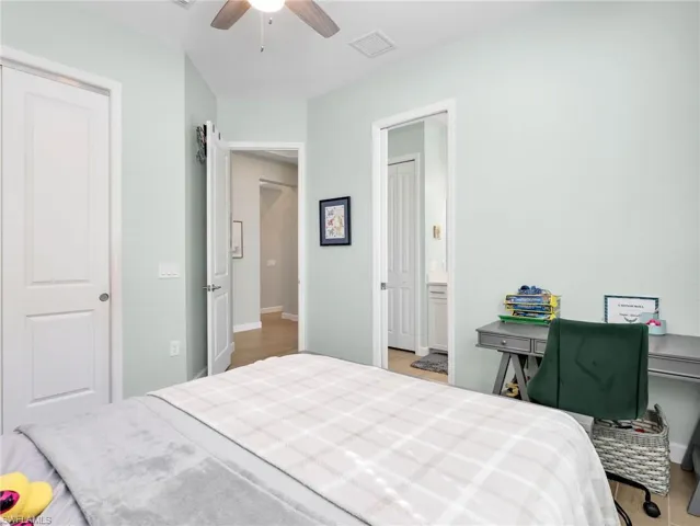 Bedroom with ceiling fan and light wood finished floors