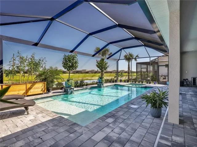 Integrated pool / spa with a patio, a lanai, and a sunroom