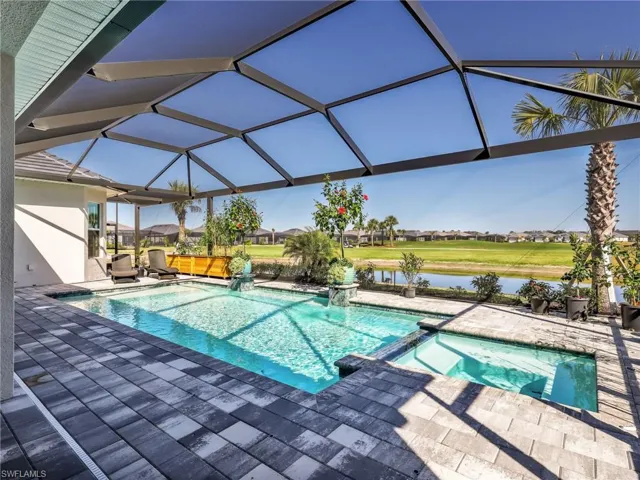 Combined pool / hot tub featuring a patio, a sunroom, a lanai, a water view, and a residential view