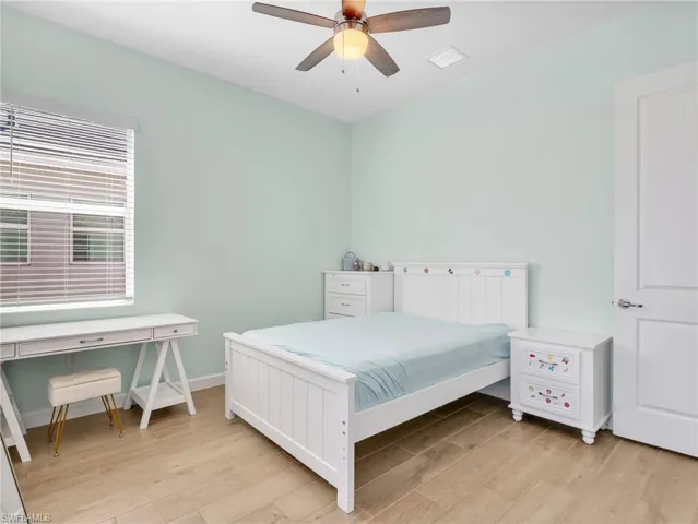 Bedroom with light wood-style flooring and a ceiling fan