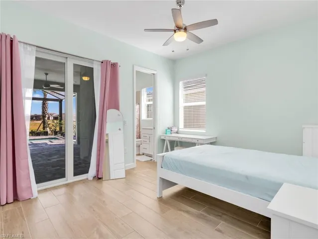 Bedroom with light wood-type flooring, access to outside, and a ceiling fan