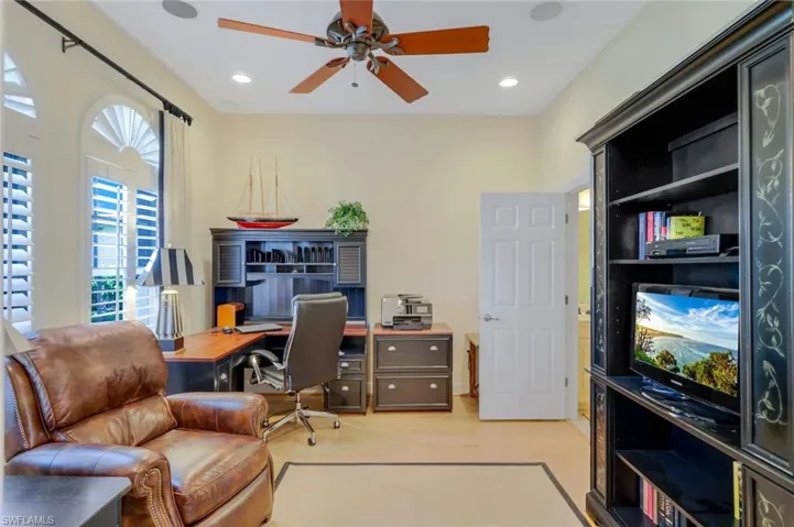 Office space with ceiling fan and light wood-type flooring