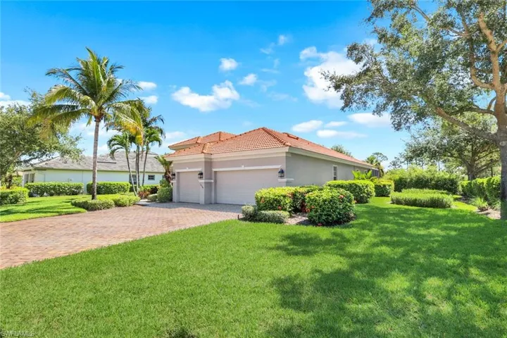 View of front of house featuring a garage and a front lawn