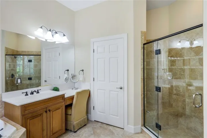 Bathroom with vanity, shower with separate bathtub, and tile patterned flooring
