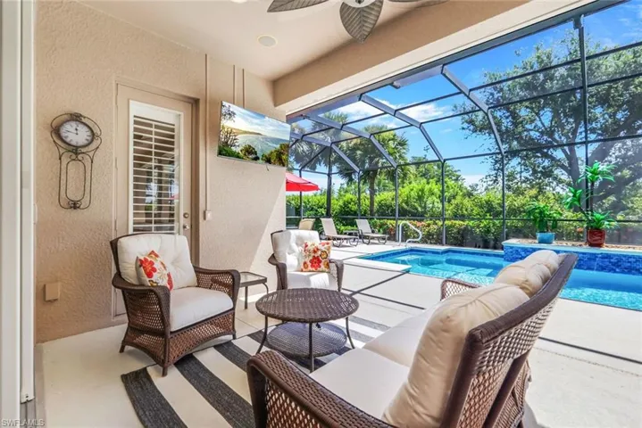 View of pool with a patio, an outdoor hangout area, and a lanai