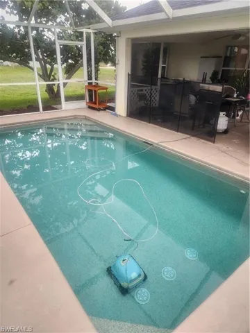 Swimming pool featuring a lanai and a sunroom