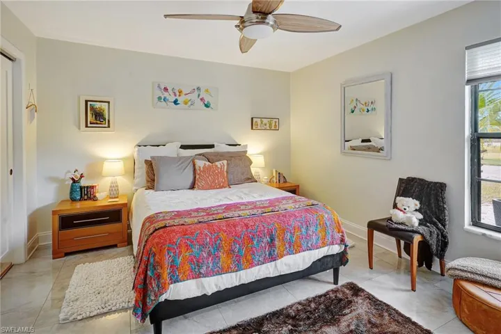Bedroom featuring baseboards and ceiling fan
