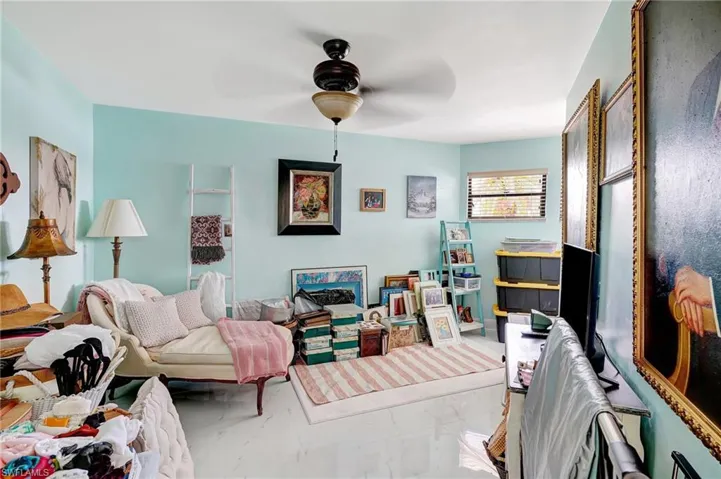 Bonus room featuring marble finish floor and ceiling fan