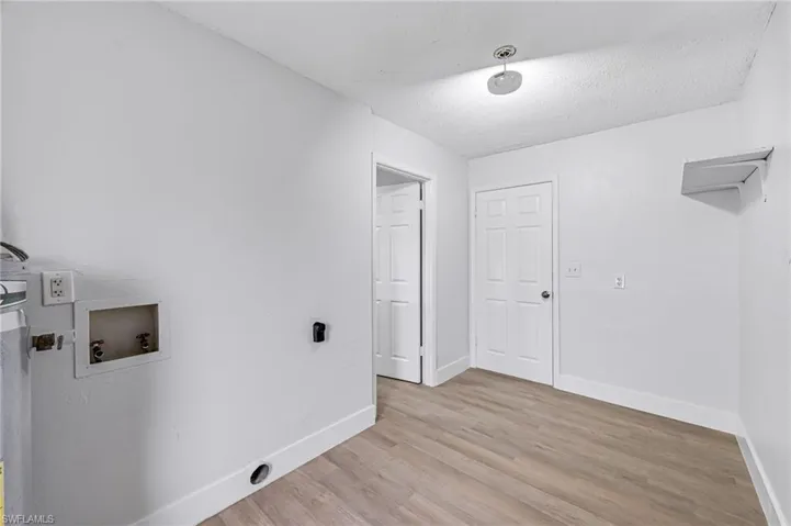 Laundry room featuring hookup for a washing machine and light hardwood / wood-style flooring